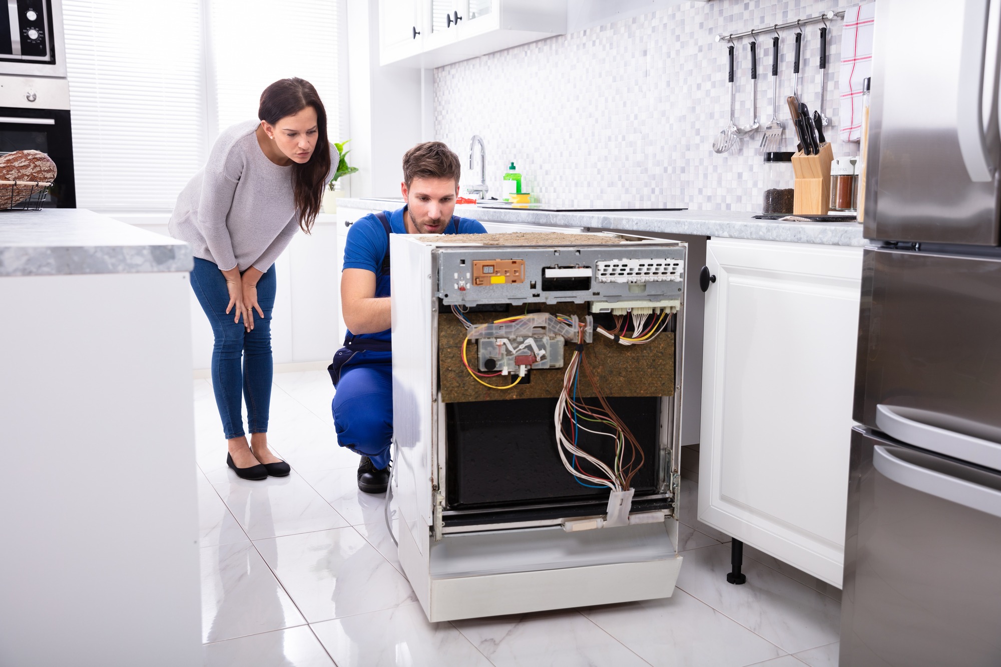 Woman with a repairman in the kitchen